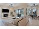 Living room offering comfortable seating, a fireplace, and serene views of the pool area at 24017 Peppercorn Rd, Punta Gorda, FL 33955