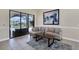 A sunlit living room with a comfy sofa, decorative art, and sliding glass doors to the pool at 24017 Peppercorn Rd, Punta Gorda, FL 33955