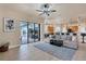 Open-concept living room with modern decor, ceramic tile, and outdoor access to the lanai at 24017 Peppercorn Rd, Punta Gorda, FL 33955