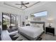 Bright main bedroom featuring modern design, private balcony access and a view of the pool at 24017 Peppercorn Rd, Punta Gorda, FL 33955