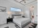 Bright main bedroom featuring modern design, contemporary furnishings and a large window at 24017 Peppercorn Rd, Punta Gorda, FL 33955