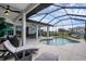 Relaxing outdoor pool area with ample seating, screened enclosure, and beautiful landscaping, perfect for enjoying sunny days at 24017 Peppercorn Rd, Punta Gorda, FL 33955