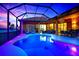 Beautiful pool area with outdoor seating at dusk, offering the perfect ambiance for relaxation and entertaining under the stars at 24017 Peppercorn Rd, Punta Gorda, FL 33955