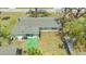 Birds-eye view of the backyard showing the green grass, patio, and a small shed at 275 Burke Rd, Venice, FL 34293