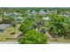 Aerial view showing the neighborhood with the vacant property lot filled with trees at 275 Burke Rd, Venice, FL 34293