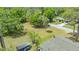 Aerial view showing the neighborhood with the vacant property lot and mature trees at 275 Burke Rd, Venice, FL 34293