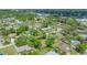 Aerial view showing the neighborhood with the house and large vacant lot with property lines at 275 Burke Rd, Venice, FL 34293