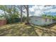 Landscaped backyard featuring a storage shed, mature trees and lush greenery at 275 Burke Rd, Venice, FL 34293
