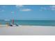 Relaxing beach scene featuring people enjoying the sun and surf with colorful umbrellas at 275 Burke Rd, Venice, FL 34293