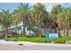 Venice Beach signage surrounded by lush tropical greenery and palm trees on a sunny day at 275 Burke Rd, Venice, FL 34293
