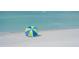 Vibrant blue and green beach umbrella adding color to a serene oceanfront setting at 275 Burke Rd, Venice, FL 34293