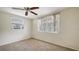 Cozy bedroom with carpet, two windows letting in natural light, and a ceiling fan at 275 Burke Rd, Venice, FL 34293