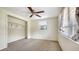Bedroom featuring carpet, closet and single window with ceiling fan above at 275 Burke Rd, Venice, FL 34293