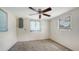 Neutral bedroom with carpet, two windows, and a functional electrical panel at 275 Burke Rd, Venice, FL 34293