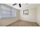 Neutral bedroom with carpet, window, and a compact wall AC unit at 275 Burke Rd, Venice, FL 34293