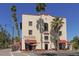 Historic KMI building showcasing unique architecture, surrounded by lush palm trees and charming street-side seating areas at 275 Burke Rd, Venice, FL 34293