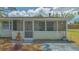 Quaint single story home with a screened porch and a welcoming entrance, showcasing its pleasant curb appeal at 275 Burke Rd, Venice, FL 34293