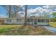 Charming front exterior with mature trees, adding character and shade to the property at 275 Burke Rd, Venice, FL 34293