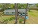Well-maintained exterior with mature trees, showcasing the home's serene setting at 275 Burke Rd, Venice, FL 34293