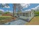 Charming single story home featuring a screened porch, set on a well-maintained lawn under a bright sky at 275 Burke Rd, Venice, FL 34293