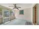 Enclosed lanai featuring screened windows, ceiling fan, and access to a backyard shed at 275 Burke Rd, Venice, FL 34293