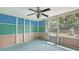 Enclosed lanai with colorful walls and screened windows, great for enjoying the outdoors at 275 Burke Rd, Venice, FL 34293