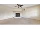 Comfortable living room features a cozy fireplace, ceiling fan, and ample lighting, creating a welcoming atmosphere at 275 Burke Rd, Venice, FL 34293