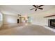 Spacious living room seamlessly connects to the kitchen, featuring a fireplace and ample space for entertaining at 275 Burke Rd, Venice, FL 34293