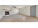 Inviting living room features a cozy fireplace and ample natural light, blending carpeted and tiled areas at 275 Burke Rd, Venice, FL 34293