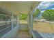 A cozy, screened-in porch offers serene views of the outdoors, perfect for relaxing in a bright, airy space at 275 Burke Rd, Venice, FL 34293