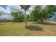 A view of a grassy vacant property lot filled with mature trees under cloudy skies at 275 Burke Rd, Venice, FL 34293