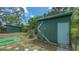 View of the green sheds in the backyard at 275 Burke Rd, Venice, FL 34293
