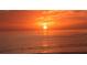Striking sunset over the water featuring an orange glow and tranquil ocean views, a perfect end to a relaxing day at 275 Burke Rd, Venice, FL 34293