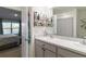 Modern bathroom features double sinks, granite countertops, stylish storage solutions, and a view of the lake at 2812 Rock Sound St, Bradenton, FL 34208