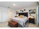 Comfortable bedroom suite includes an ensuite bathroom, floral wall art, and decorative yellow and blue pillows at 2812 Rock Sound St, Bradenton, FL 34208