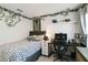 Cozy bedroom with an efficient workspace, decorated with hanging foliage, a Trans Am poster, and a floating shelf at 2812 Rock Sound St, Bradenton, FL 34208