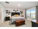 Comfortable bedroom featuring a large window offering views of the water, and decorative flower artwork above the headboard at 2812 Rock Sound St, Bradenton, FL 34208