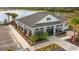 An aerial shot of the clubhouse with landscaping, featuring an outdoor seating area and nearby parking at 2812 Rock Sound St, Bradenton, FL 34208