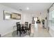 Cozy dining area with a round table, black chairs, a mirror, and view of the living area at 2812 Rock Sound St, Bradenton, FL 34208