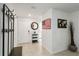 Inviting entryway with tile flooring, coat rack, a round mirror, and an American flag wall decor at 2812 Rock Sound St, Bradenton, FL 34208