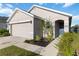 Well-maintained home exterior with landscaped front yard, walkway, and attached two-car garage at 2812 Rock Sound St, Bradenton, FL 34208