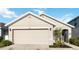 View of the garage featuring neutral siding, white trim, and a welcoming front entrance at 2812 Rock Sound St, Bradenton, FL 34208