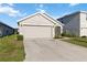 Single-story home with a long driveway and attached two-car garage in a residential neighborhood at 2812 Rock Sound St, Bradenton, FL 34208