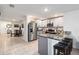 Bright kitchen with stainless steel appliances, gray cabinetry, granite countertops, and breakfast bar seating at 2812 Rock Sound St, Bradenton, FL 34208