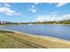 Beautiful lake view with a fountain, trees, and neighborhood homes in the background under a partly cloudy sky at 2812 Rock Sound St, Bradenton, FL 34208