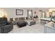 Open-concept living room with tile flooring, comfortable seating, and seamless transition to the kitchen at 2812 Rock Sound St, Bradenton, FL 34208