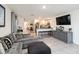 Open-concept living room with tile flooring, comfortable seating, and seamless transition to the kitchen at 2812 Rock Sound St, Bradenton, FL 34208