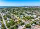 Expansive aerial view capturing city and ocean views with the house in a tree-lined neighborhood at 2840 S Shade Ave, Sarasota, FL 34239