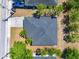 Aerial view of a home with a dark roof, brick driveway, and some surrounding trees at 2840 S Shade Ave, Sarasota, FL 34239