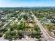 Wide aerial view of residential street with mature trees, nearby ocean, and city in the distance at 2840 S Shade Ave, Sarasota, FL 34239